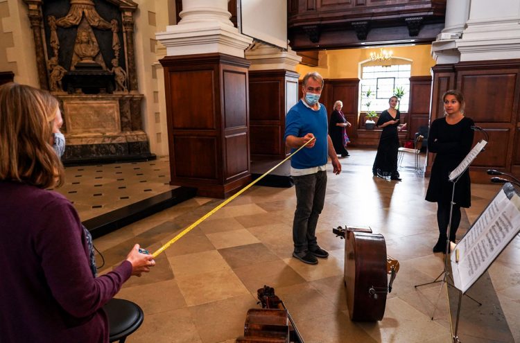 Projects Officer Sophie Adams (left) with our CEO Crispin Woodhead (centre) measuring social distance space in preparation for the recording of 'Strings Reunited' at Christ Church, Spitalfields. © Zen Grisdale
